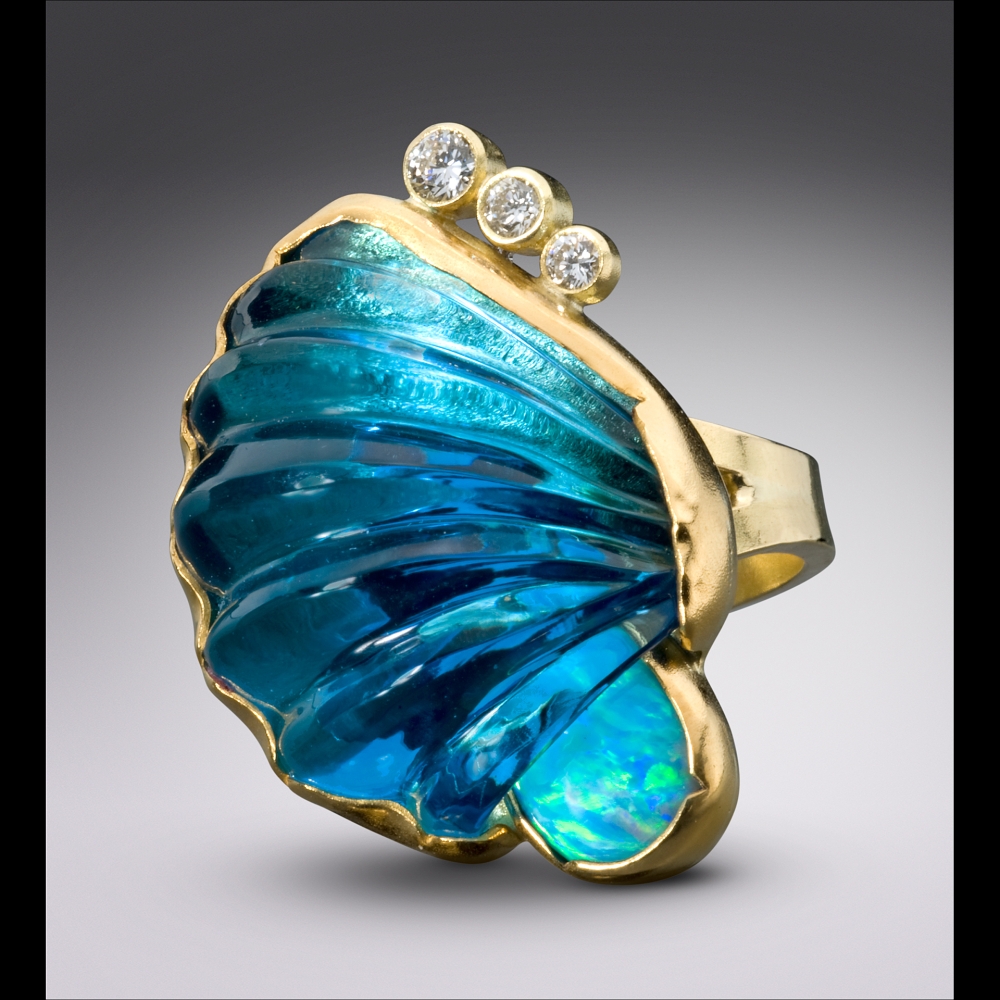 Breaking Wave Ring with Hand Carved Blue Topaz

1.88&amp;quot; x 1.25&amp;quot; x 1.38&amp;quot;