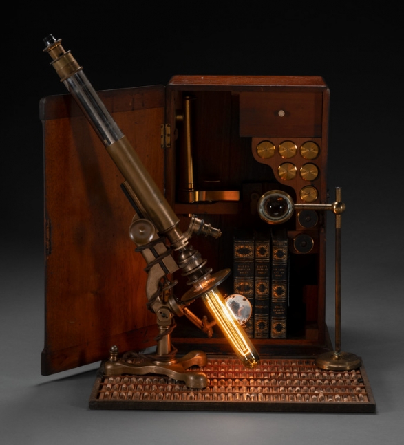 sculpture of an illuminated microscope and box
